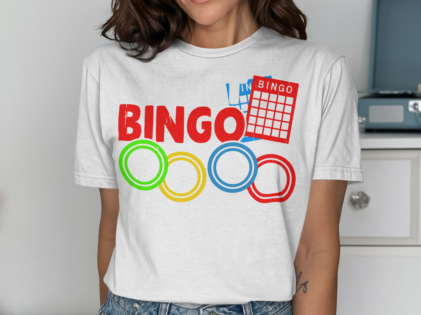 Red, green, yellow, and blue bingo rings below a bingo card and the word "BINGO".