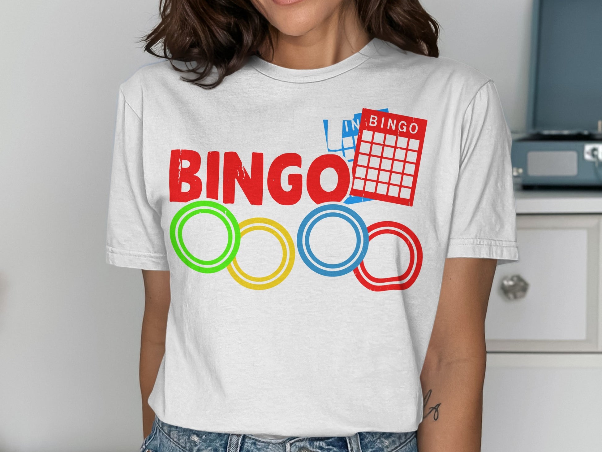 Red, green, yellow, and blue bingo rings below a bingo card and the word "BINGO".