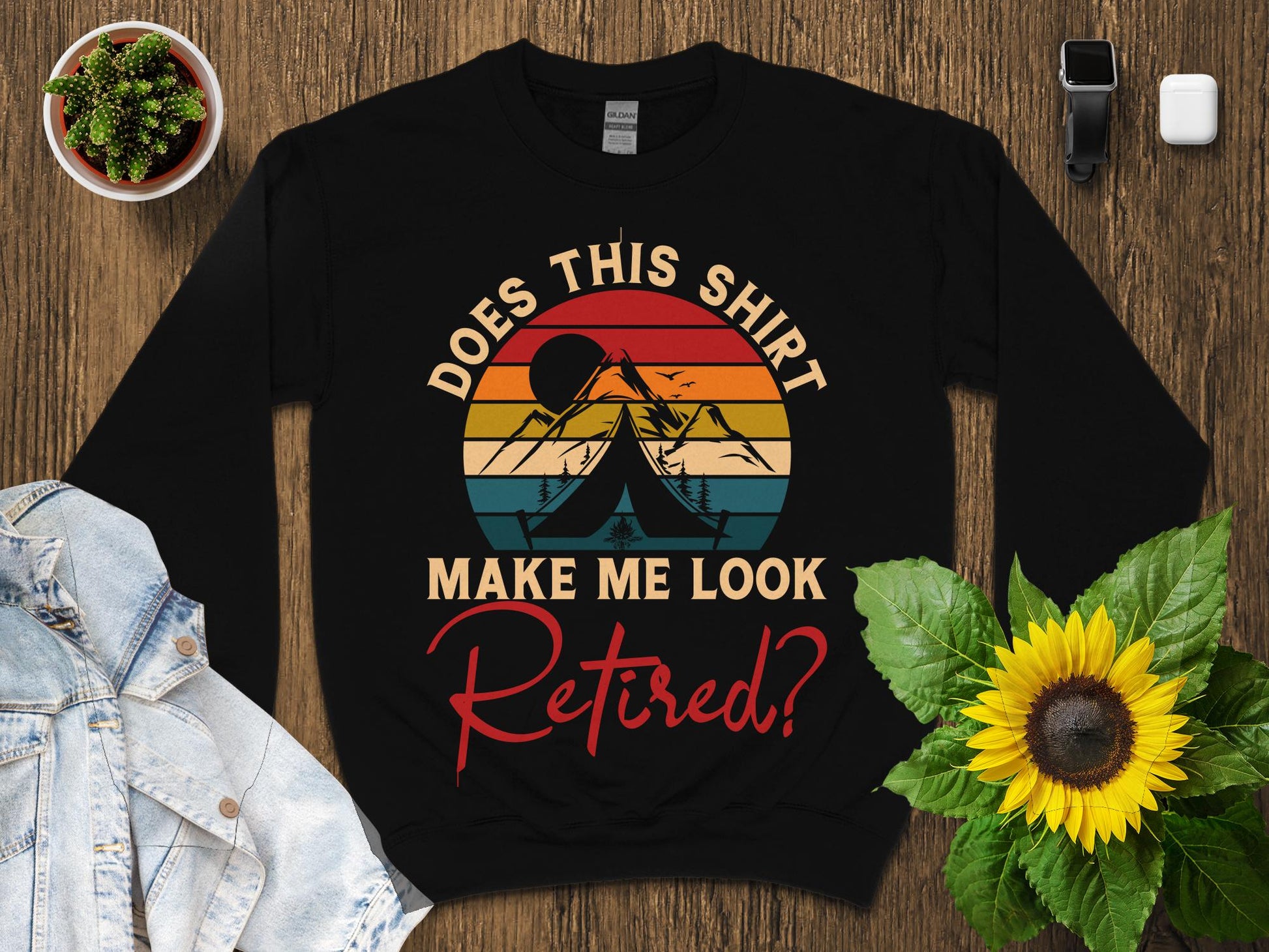 Black sweatshirt with "Does this shirt make me look retired?" text and mountain graphic.