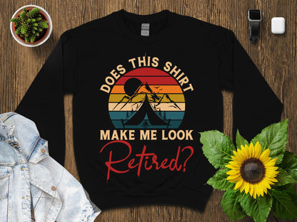 Black sweatshirt with "Does this shirt make me look retired?" text and mountain graphic.