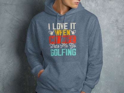 Blue hoodie with "I LOVE IT WHEN MY WIFE LET'S ME GO GOLFING" text.