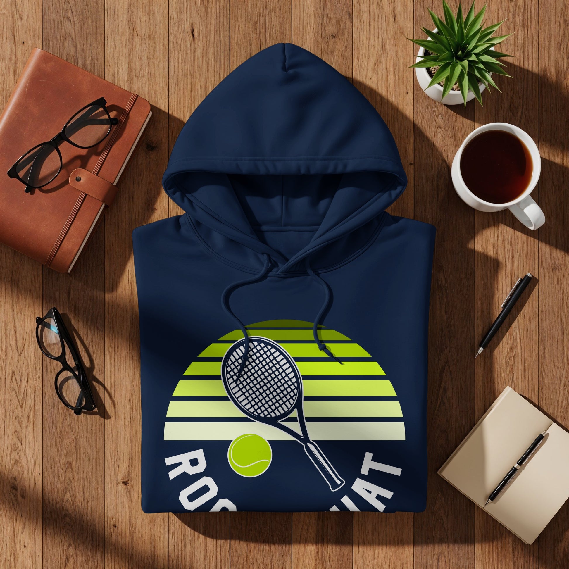 Navy hoodie with tennis racket, ball, and "Rock That" text on striped background.