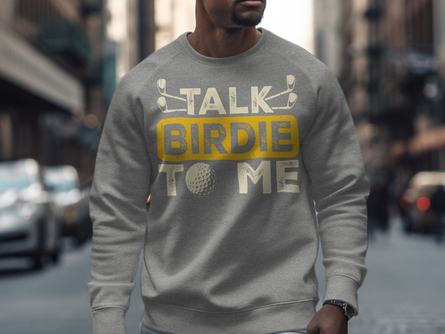 Gray sweatshirt with "Talk Birdie to Me" text and golf ball graphic.