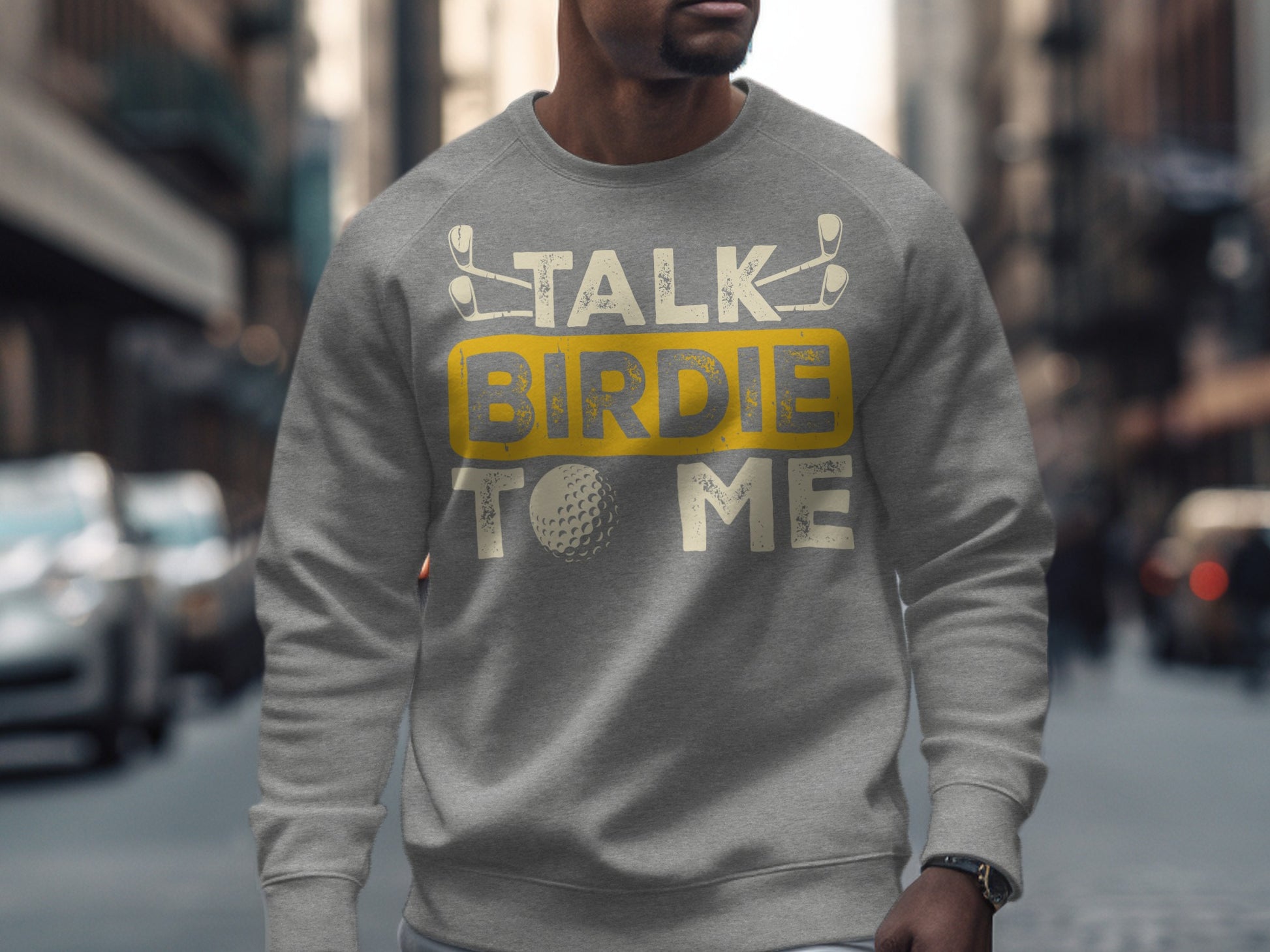 Gray sweatshirt with "Talk Birdie to Me" text and golf ball graphic.