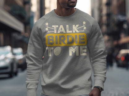 Gray sweatshirt with "Talk Birdie to Me" text and golf ball graphic.