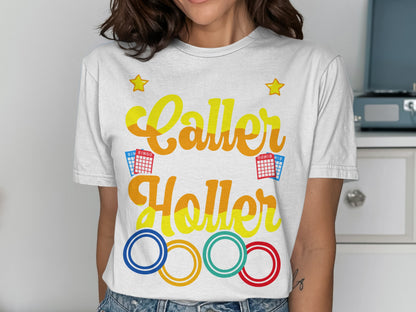 T-shirt with "Caller Holler" in colorful lettering, bingo cards, and Olympic rings.