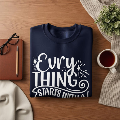 Navy sweatshirt with white text "Evry thing starts with".