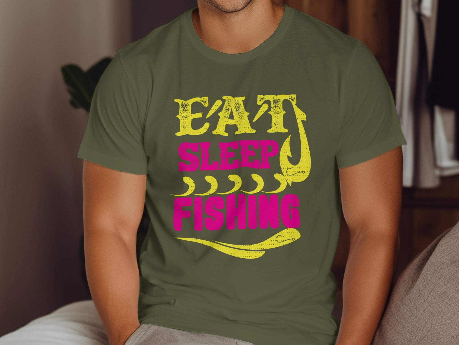 Green t-shirt with "Eat Sleep Fishing" text and fishing hook design.