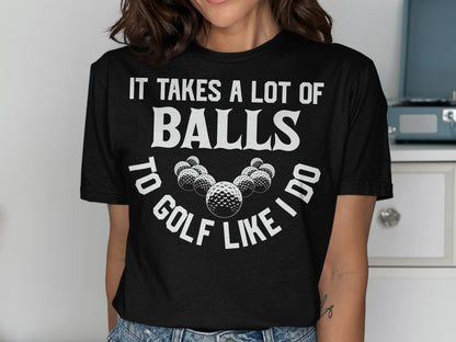 Black t-shirt with "It takes a lot of balls to golf like I do" and golf balls.