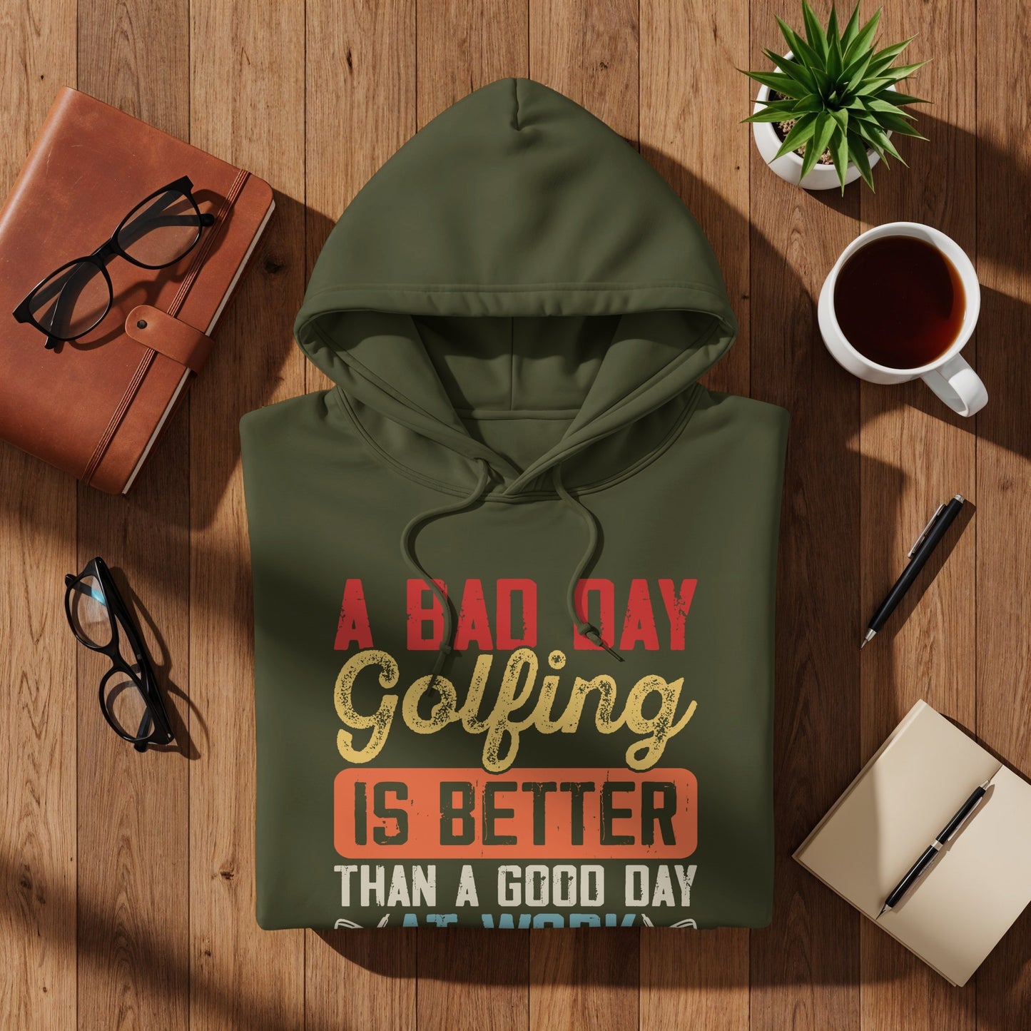 Olive green hoodie with text: "A Bad Day Golfing Is Better Than A Good Day At Work".