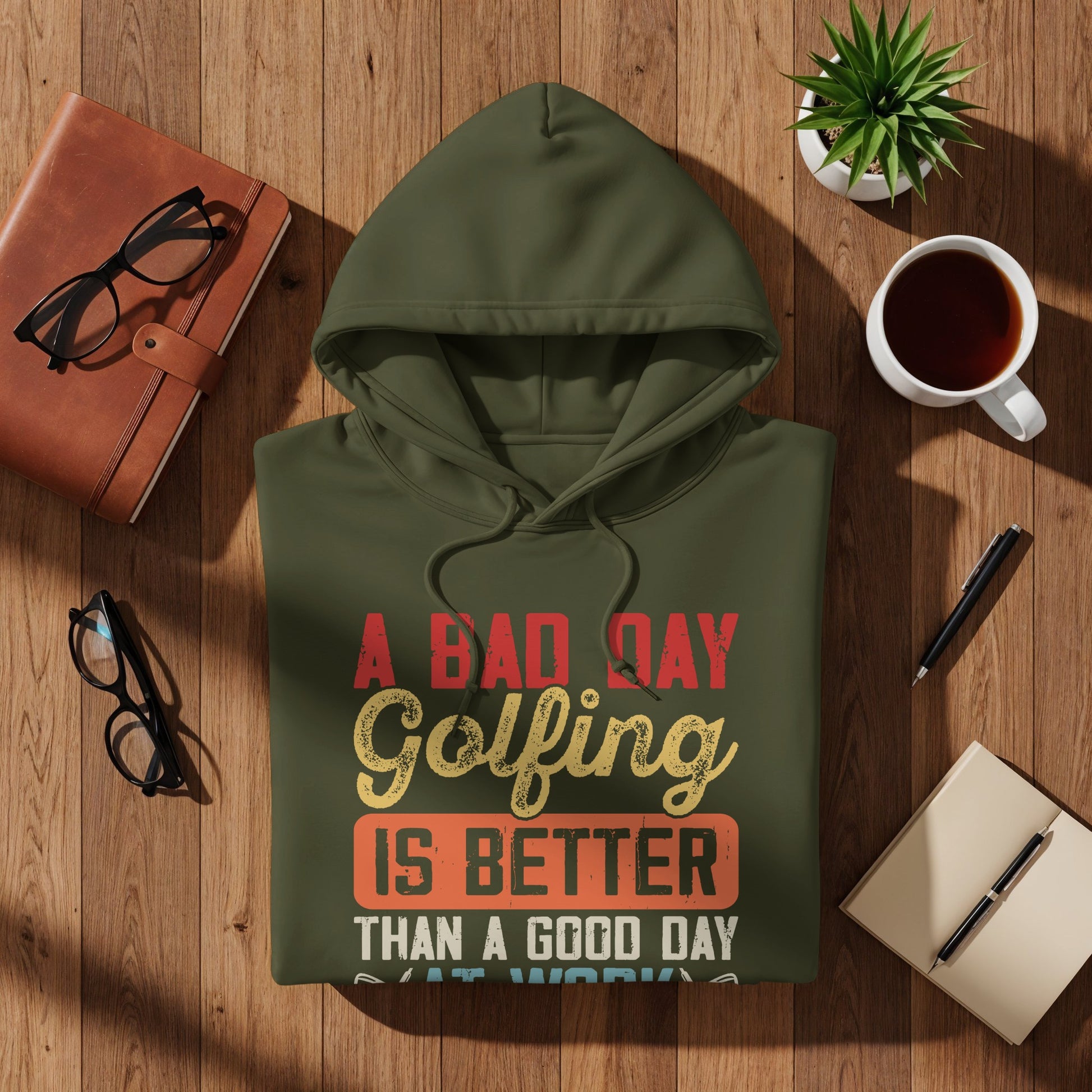 Olive green hoodie with text: "A Bad Day Golfing Is Better Than A Good Day At Work".
