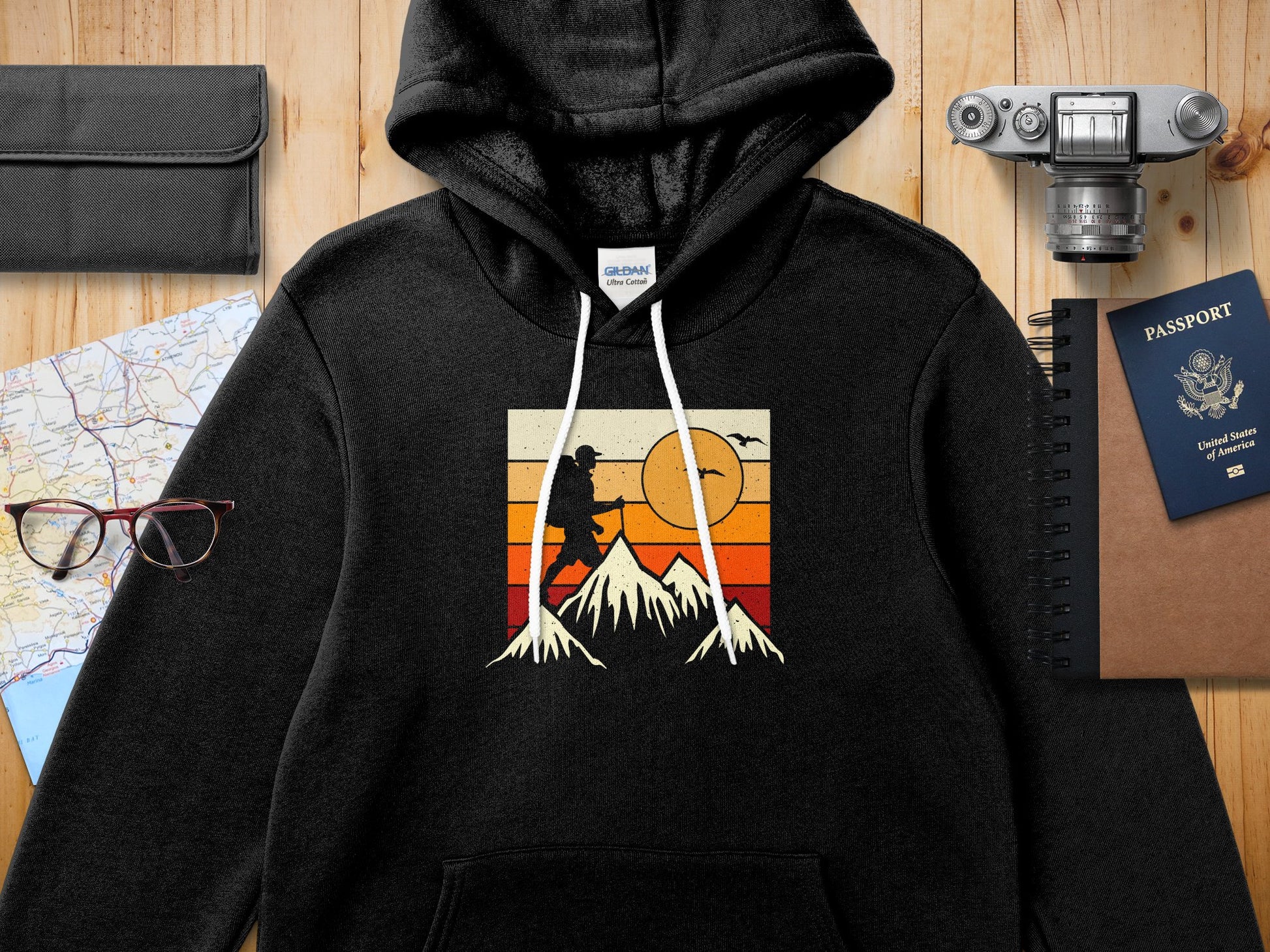Black hoodie with vintage mountain hiker graphic and United States passport.