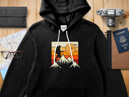 Black hoodie with vintage mountain hiker graphic and United States passport.