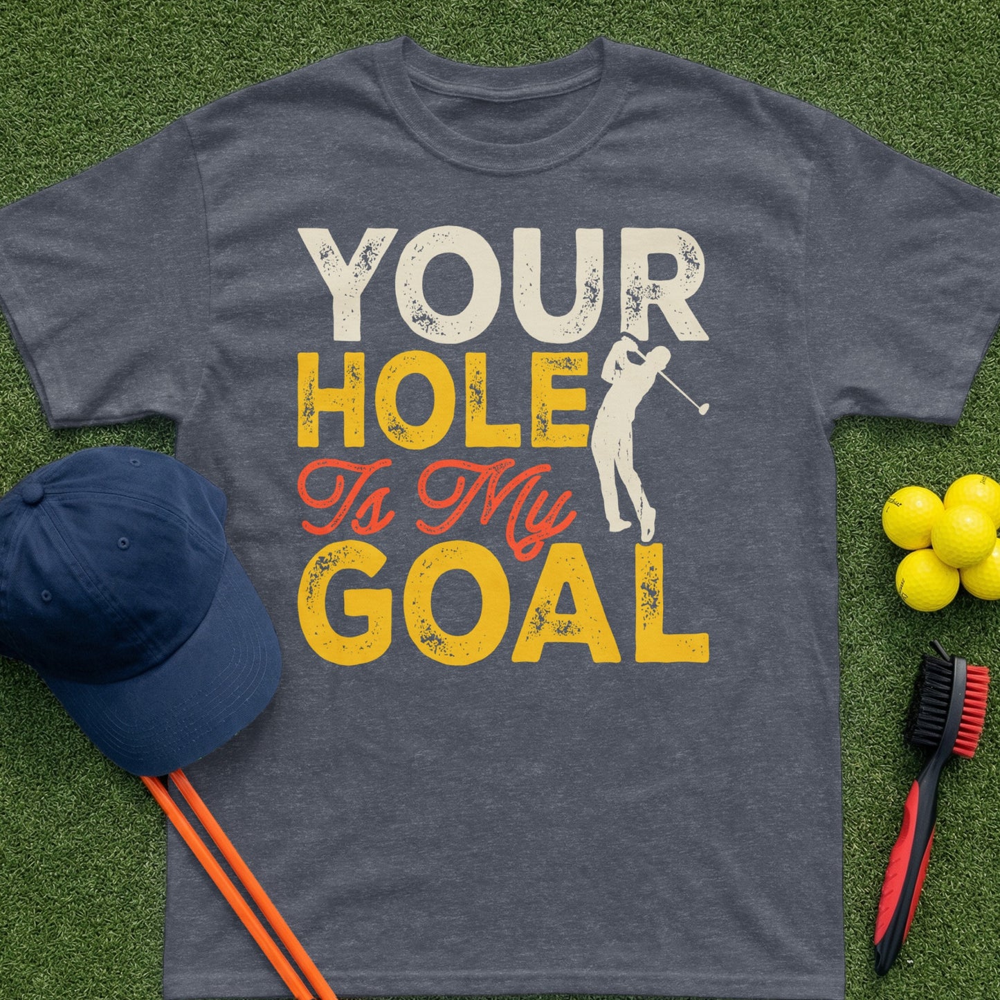 Golf t-shirt with text "Your Hole Is My Goal" and golf accessories.