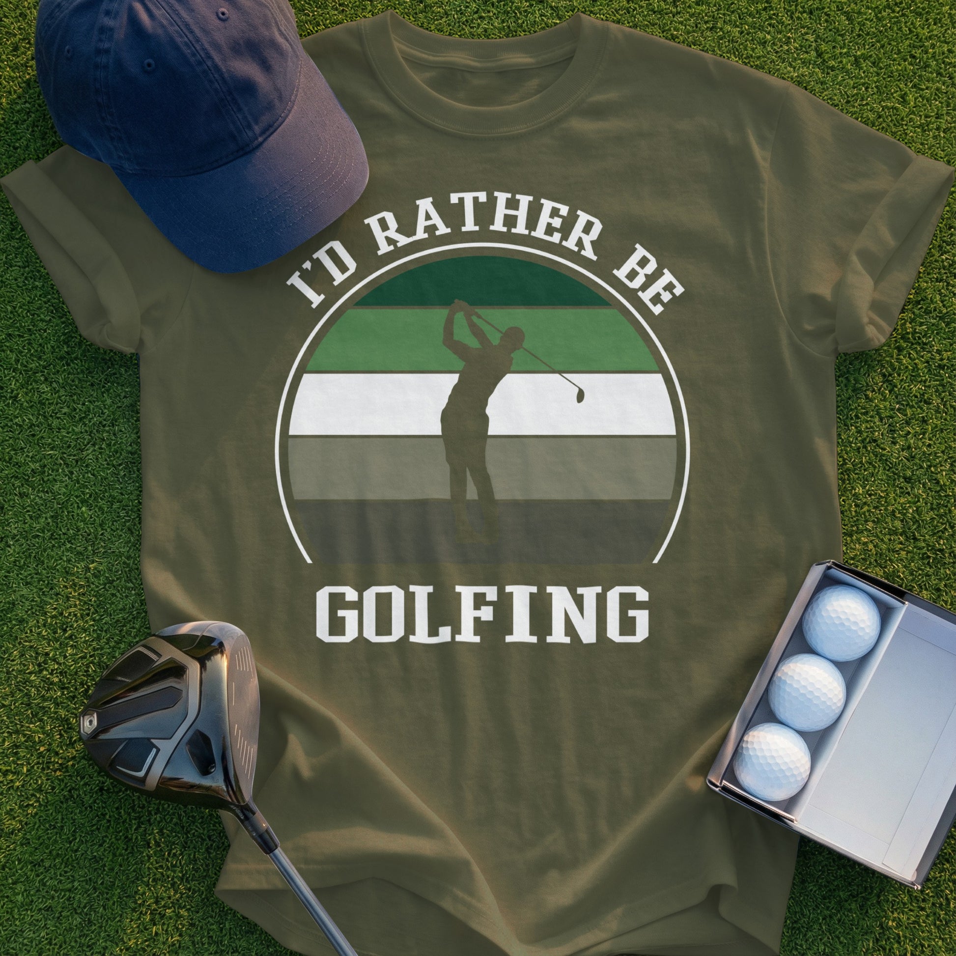 Olive green t-shirt with "I'd rather be golfing" text and golfer silhouette graphic.