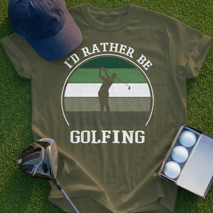 Olive green t-shirt with "I'd rather be golfing" text and golfer silhouette graphic.
