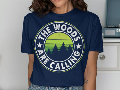 Navy t-shirt with "The Woods Are Calling" text and stylized forest scene.