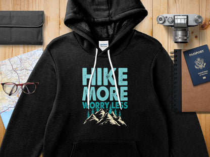 Black hoodie with "Hike More Worry Less" graphic and mountain illustration.