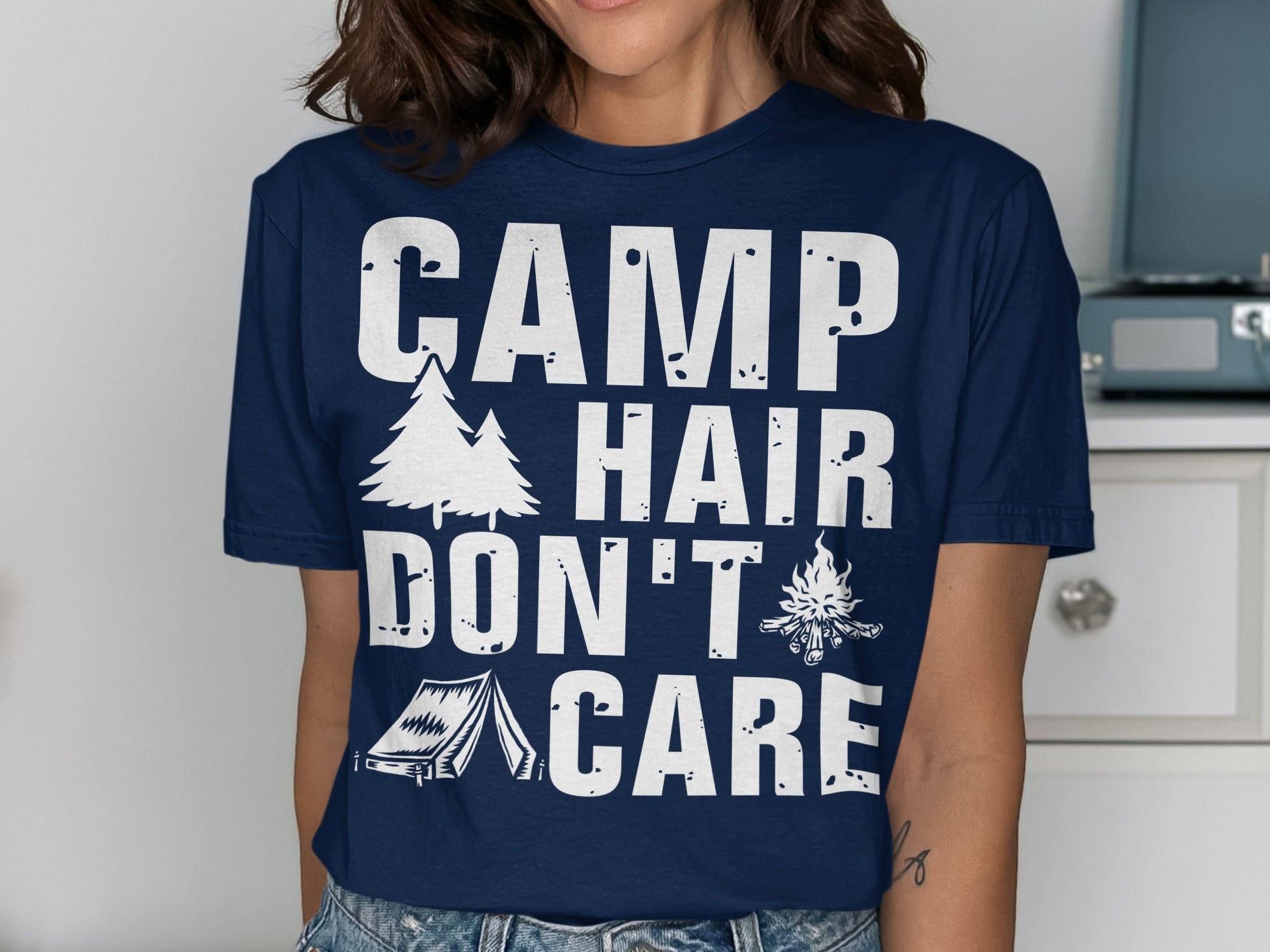 Navy t-shirt with "CAMP HAIR DON'T CARE" text and camping graphics.