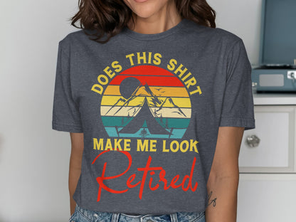 Dark t-shirt with text "DOES THIS SHIRT MAKE ME LOOK RETIRED" and mountain sunset graphic.