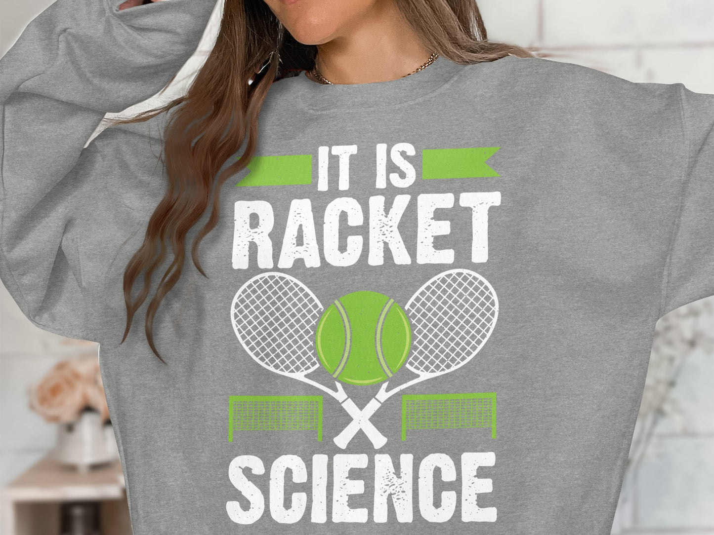 Grey sweatshirt with "It is Racket Science" text and tennis graphics.