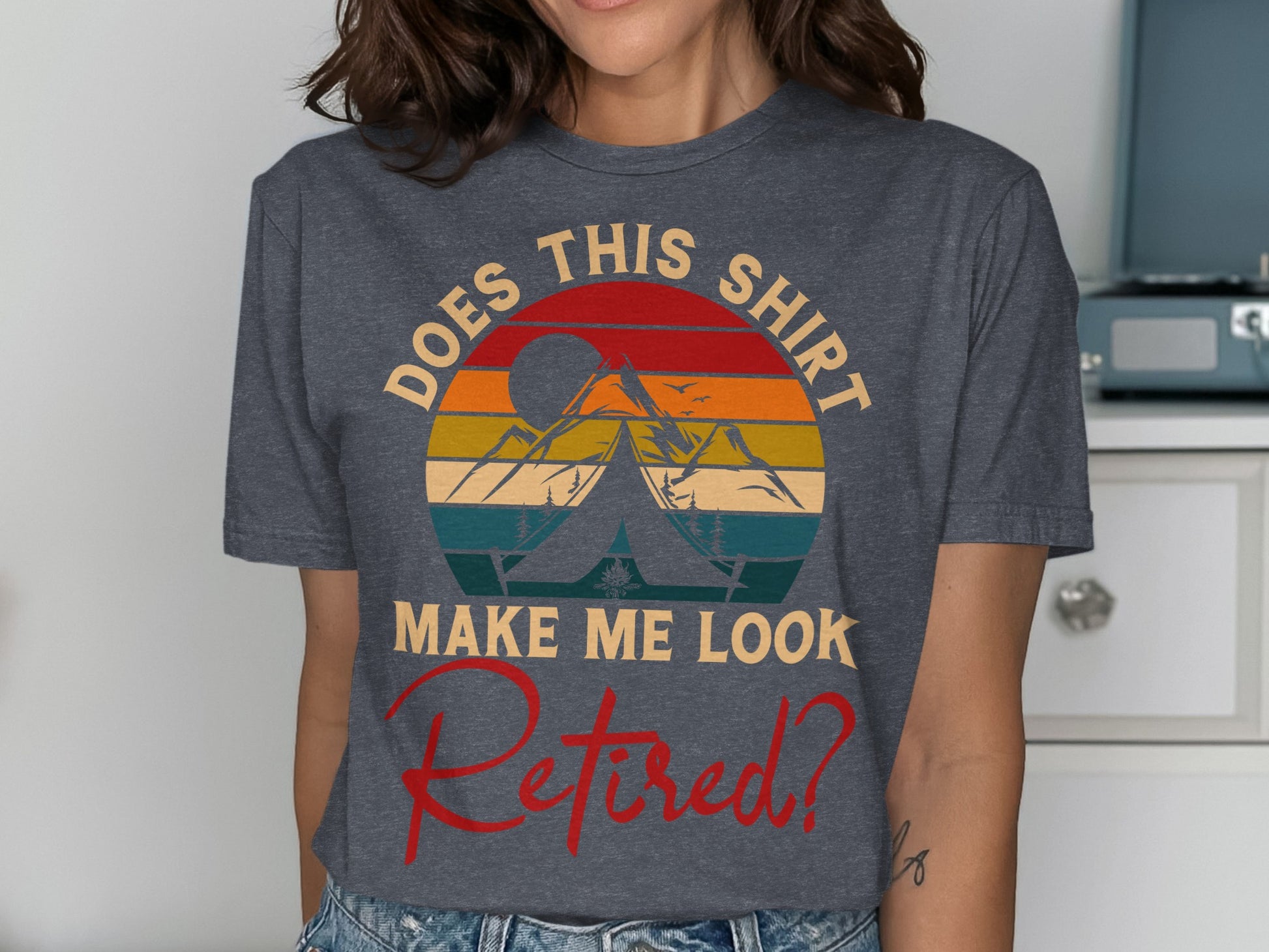 T-shirt with "Does this shirt make me look retired?" text and mountain graphic.