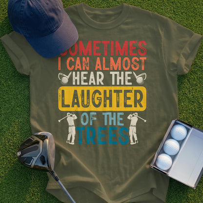 Olive green t-shirt with golf humor text: "Sometimes I Can Almost Hear The Laughter Of The Trees".