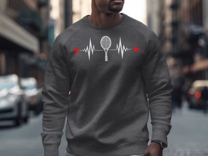 Man wearing a dark grey sweatshirt with a tennis racket and heartbeat graphic.