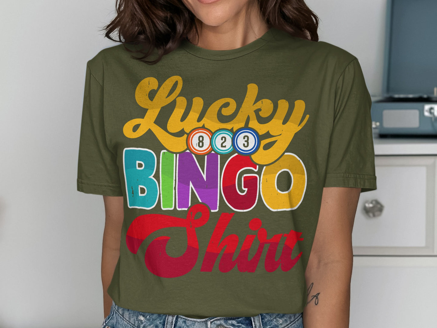 Green t-shirt with "Lucky Bingo Shirt" text and colorful bingo balls.