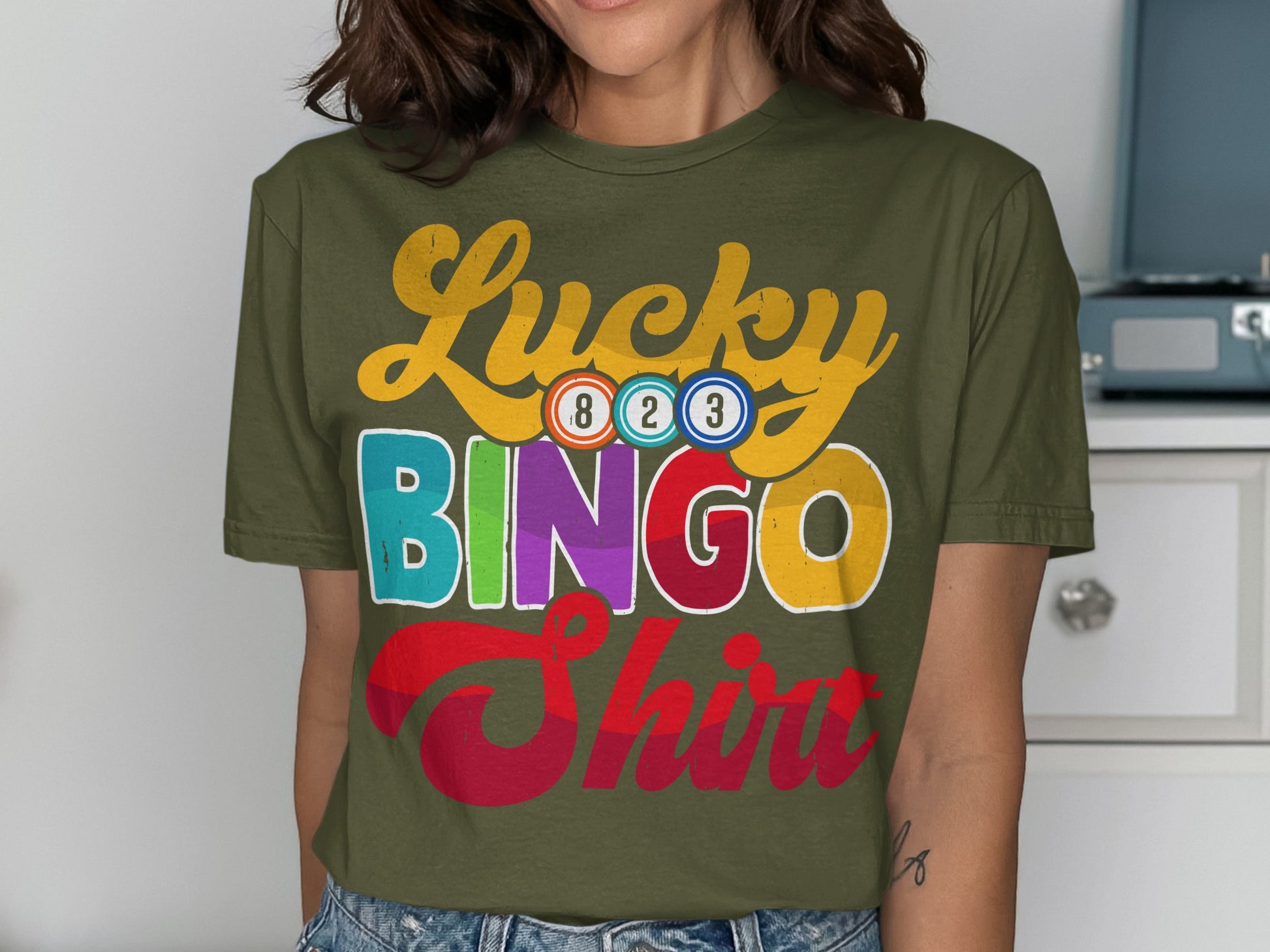 Green t-shirt with "Lucky Bingo Shirt" text and colorful bingo balls.