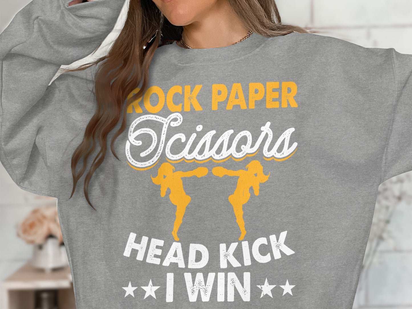 Grey sweatshirt with "Rock Paper Scissors Head Kick I Win" text and graphics.