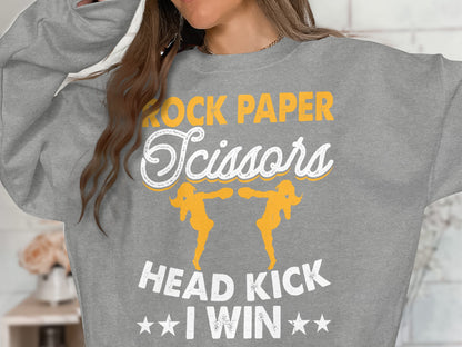 Grey sweatshirt with "Rock Paper Scissors Head Kick I Win" text and graphics.