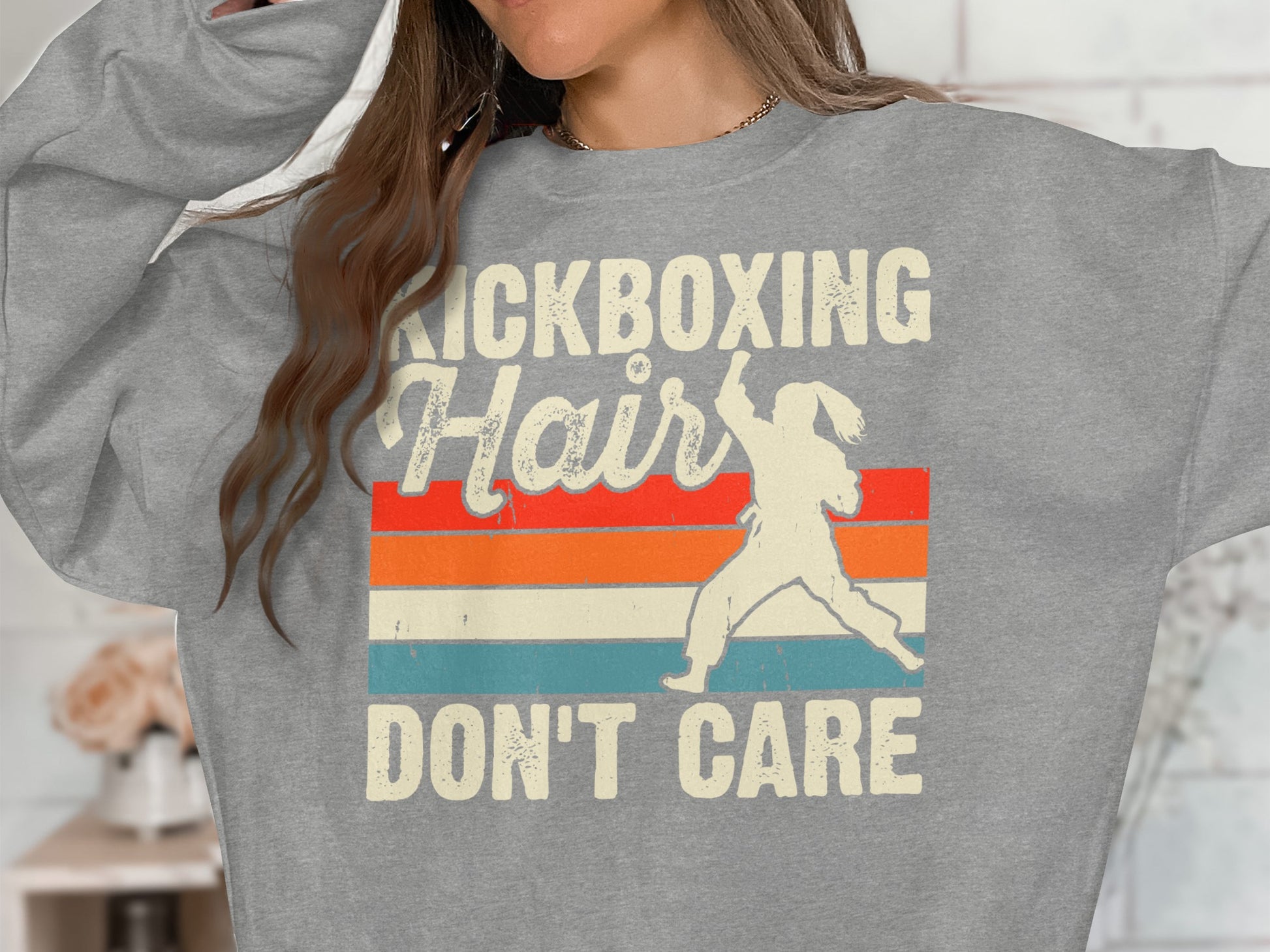 Grey sweatshirt with "Kickboxing Hair Don't Care" text and silhouette of a kickboxer.