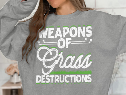 Grey sweatshirt with "Weapons of Grass Destructions" text and golf clubs.