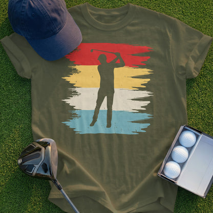 Olive green t-shirt with a golfer graphic and a cap and golf balls nearby.