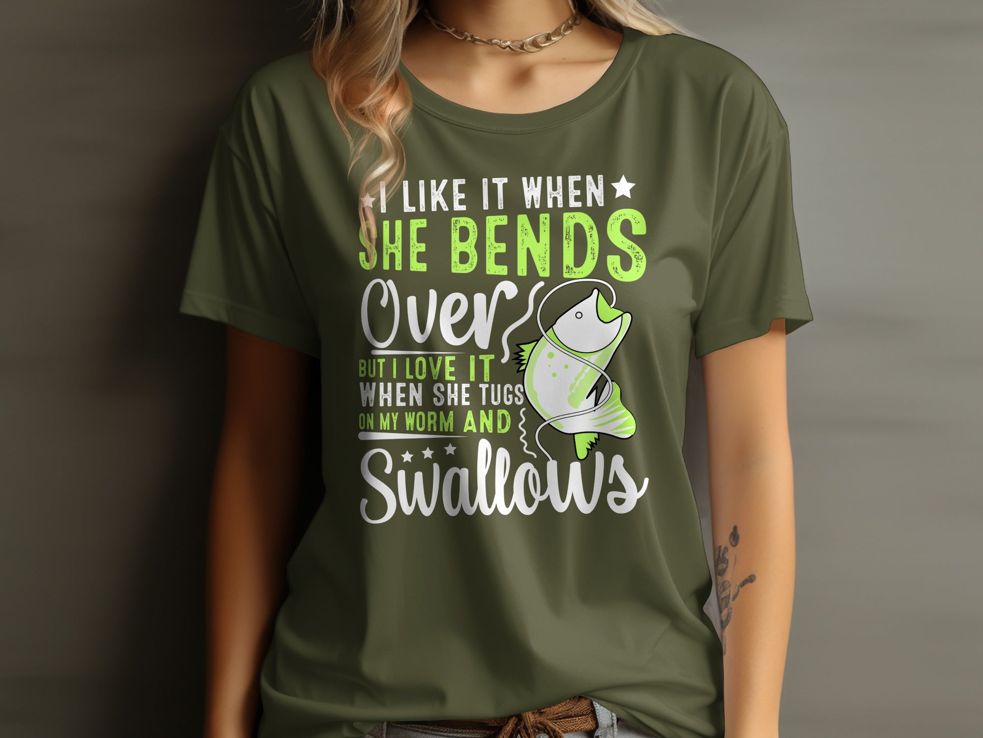 Green t-shirt with text and a cartoon fish catching a worm.