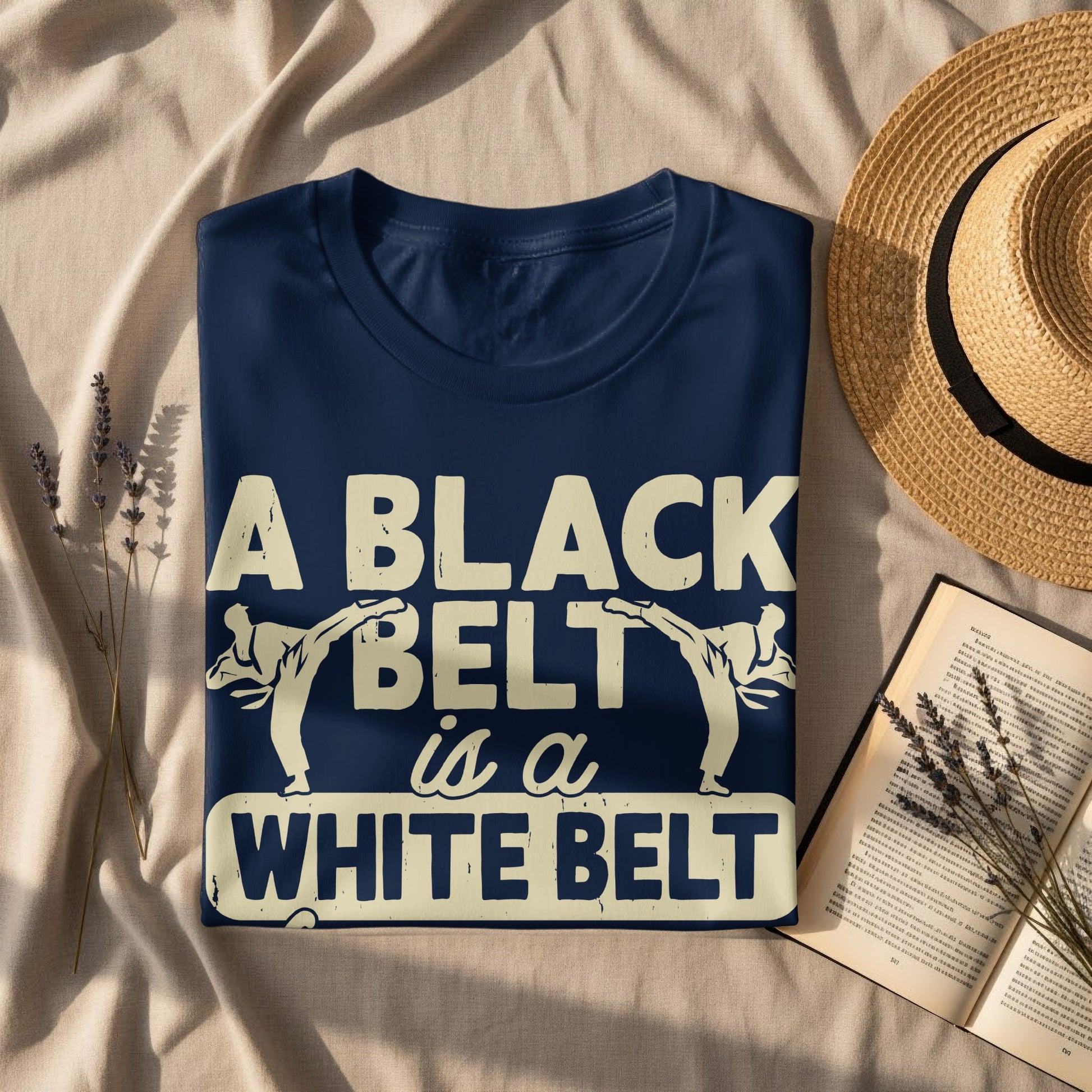 Navy t-shirt with "A BLACK BELT is a WHITE BELT" graphic.