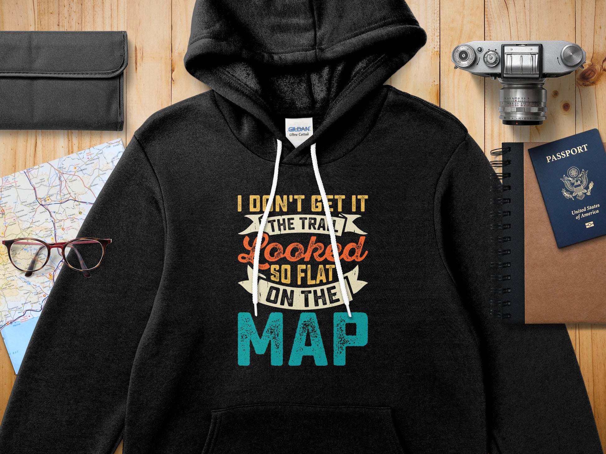 Black hooded sweatshirt with text "I DON'T GET IT THE TRA LOOKED SO FLAT ON THE MAP".