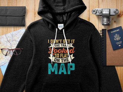 Black hooded sweatshirt with text "I DON'T GET IT THE TRA LOOKED SO FLAT ON THE MAP".
