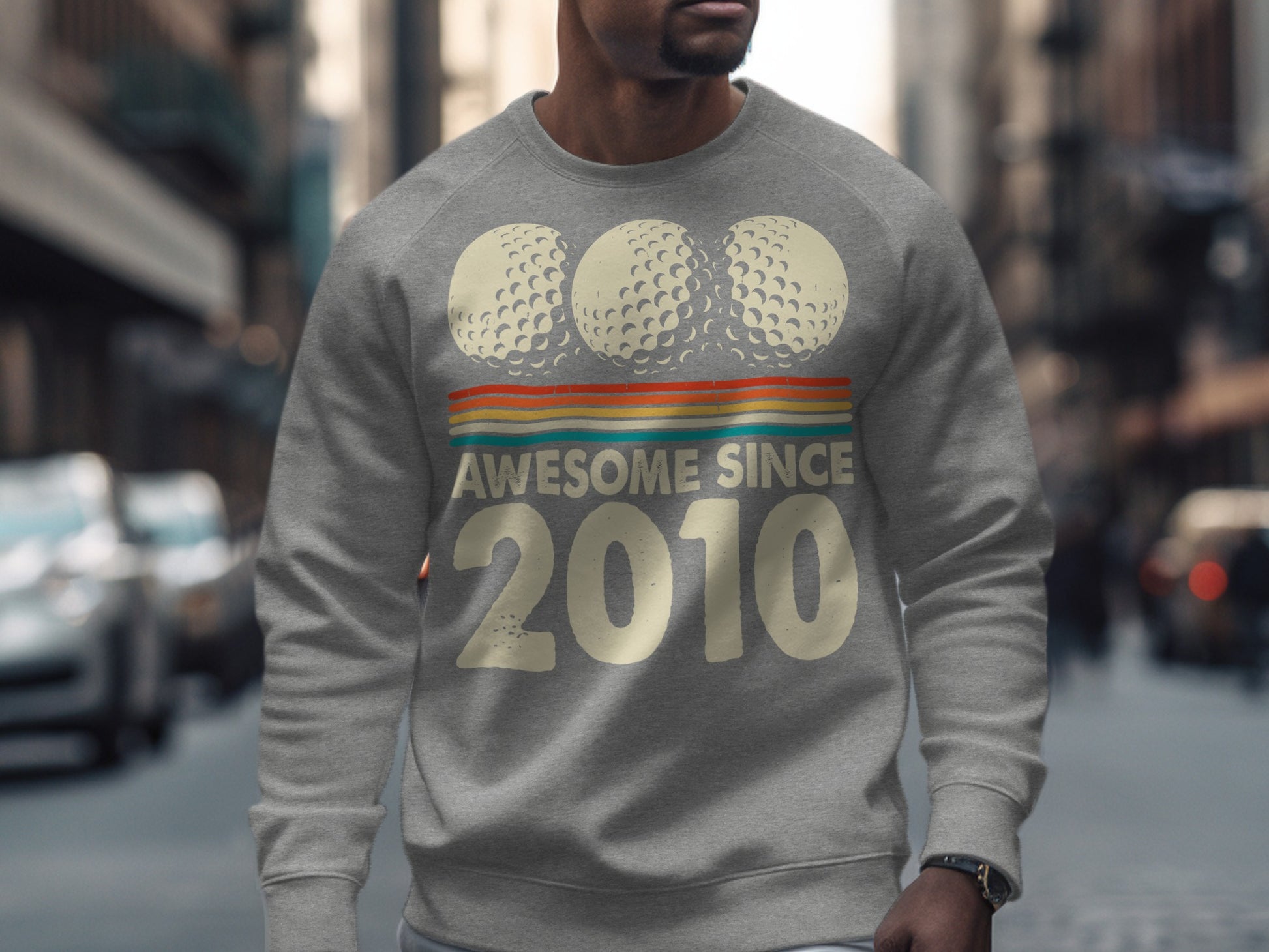 Gray sweatshirt with "Awesome Since 2010" and three golf balls.