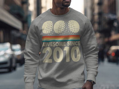 Gray sweatshirt with "Awesome Since 2010" and three golf balls.