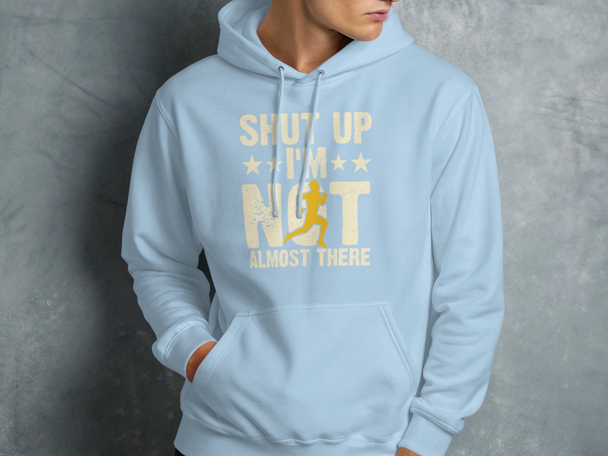 Light blue hoodie with "Shut Up I'm Not Almost There" text and runner graphic.