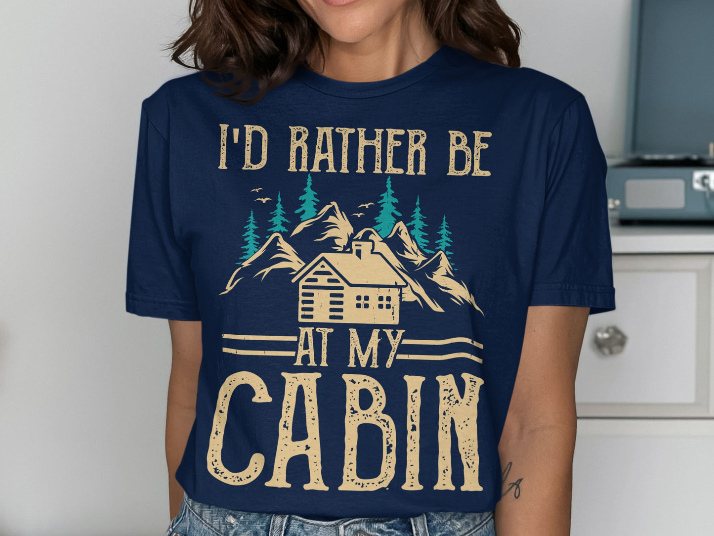 Navy t-shirt with "I'd rather be at my cabin" text and mountain scene.