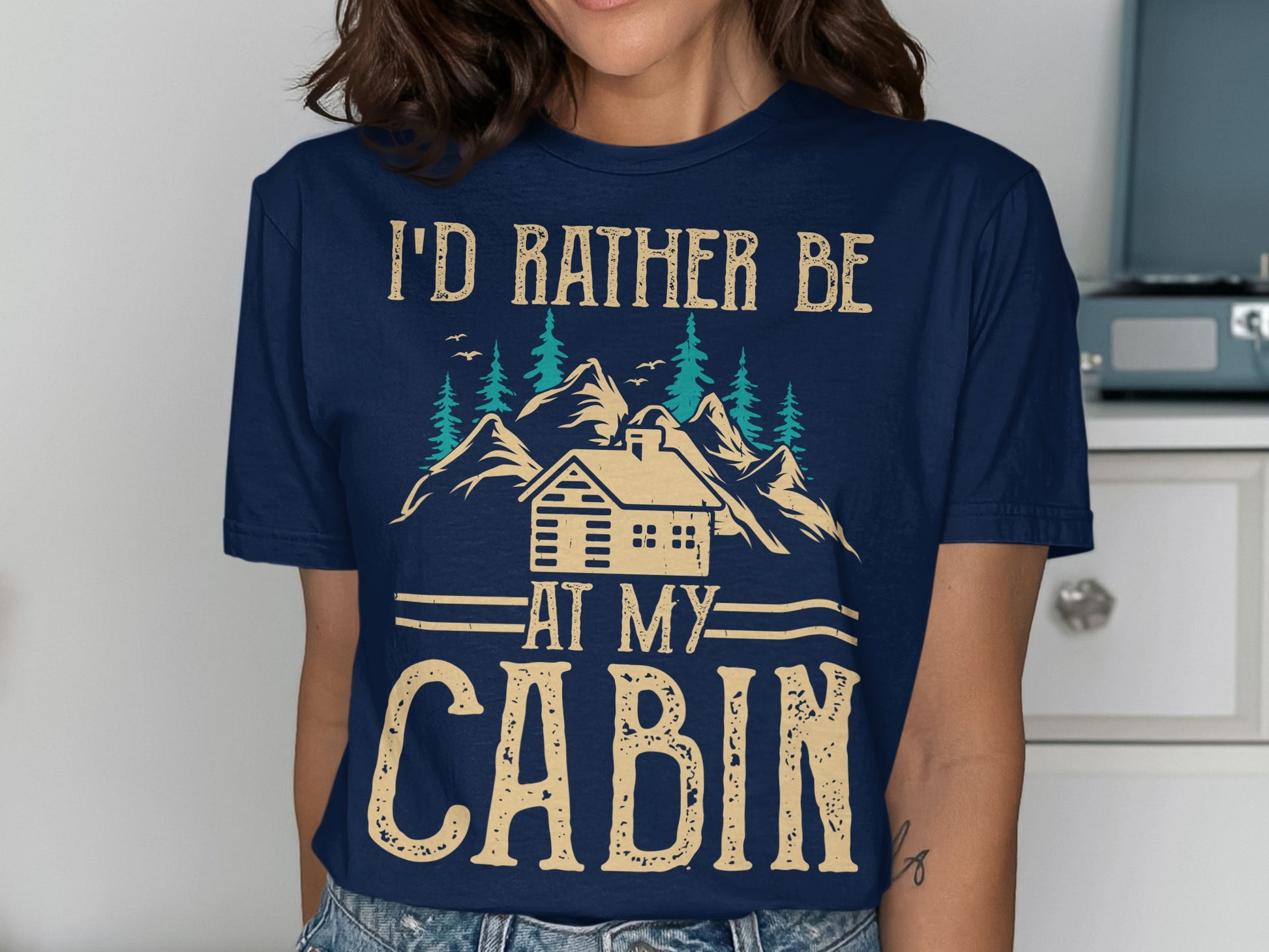 Navy t-shirt with "I'd rather be at my cabin" text and mountain scene.