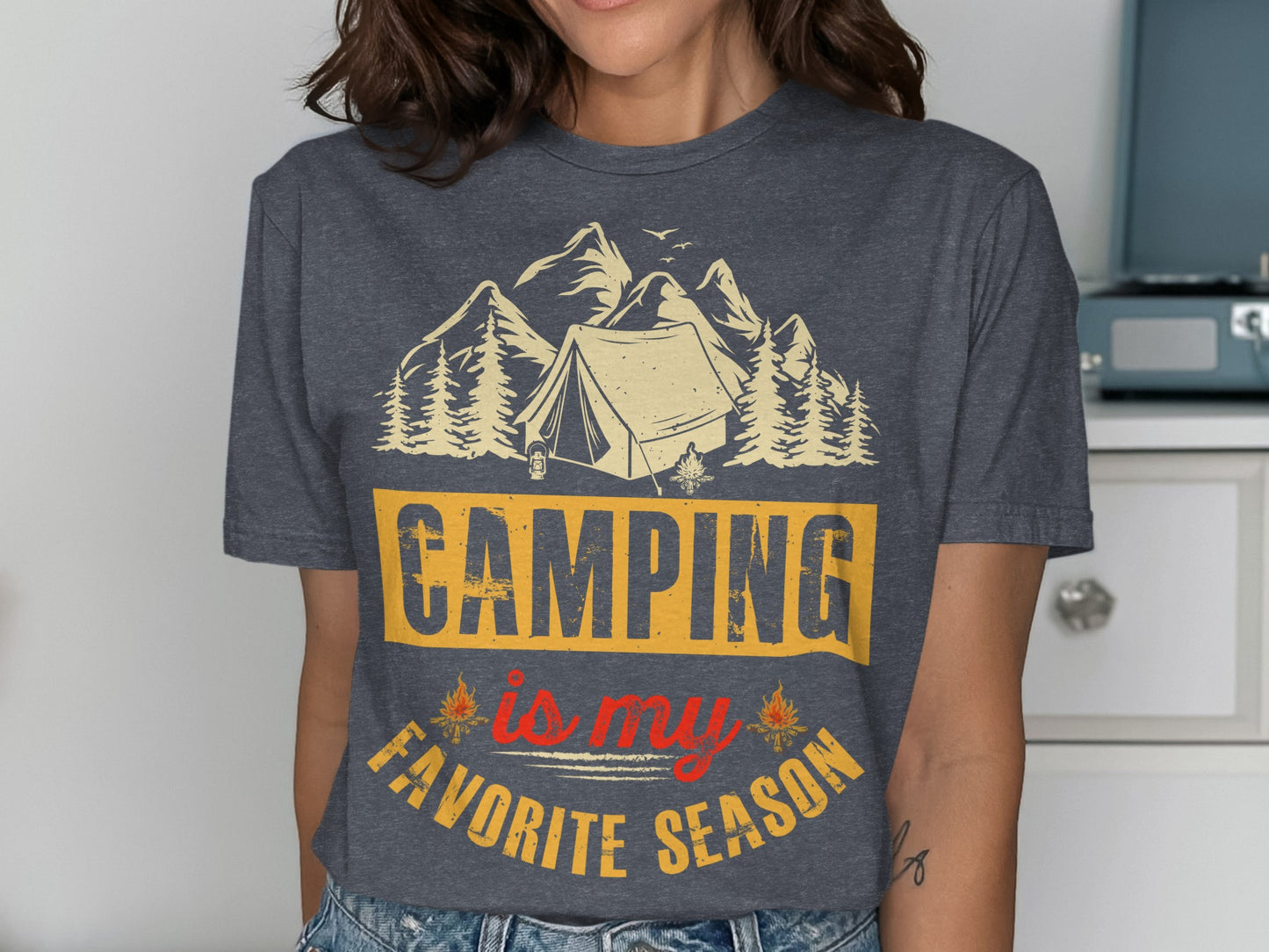 T-shirt with "Camping is my favorite season" text and mountain and tent graphic.