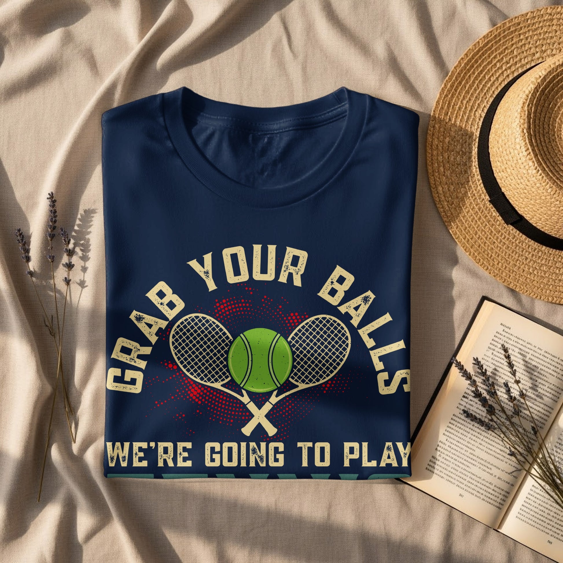 Dark blue t-shirt with "GRAB YOUR BALLS WE'RE GOING TO PLAY" text and tennis graphics.