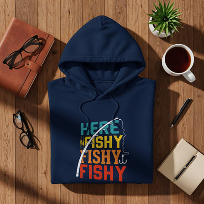 Navy hoodie with "Here Fishy Fishy" graphic, laid flat with accessories.