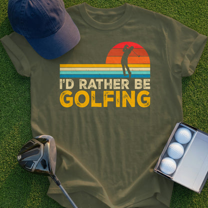 Green t-shirt with "I'd Rather Be Golfing" text and a golfer silhouette against a sunset.