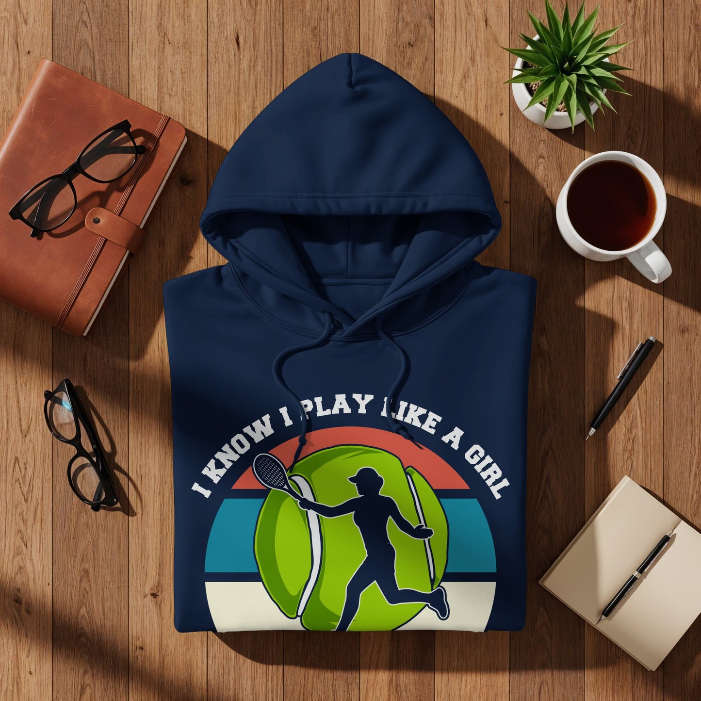 Navy hoodie with "I know I play like a girl" text and tennis player graphic.