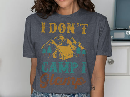Dark grey t-shirt with text "I DON'T CAMP I Glamp" and mountain tent graphic.